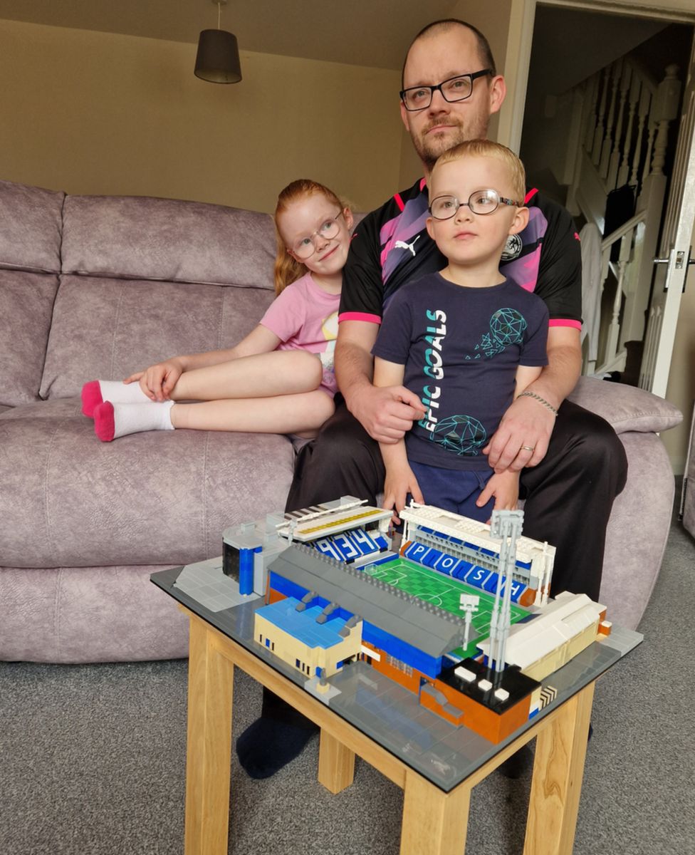 Brady Clark and his two children with his Lego version of Peterborough Utd's stadium