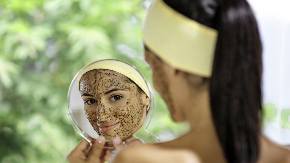 A woman with facial scrub on