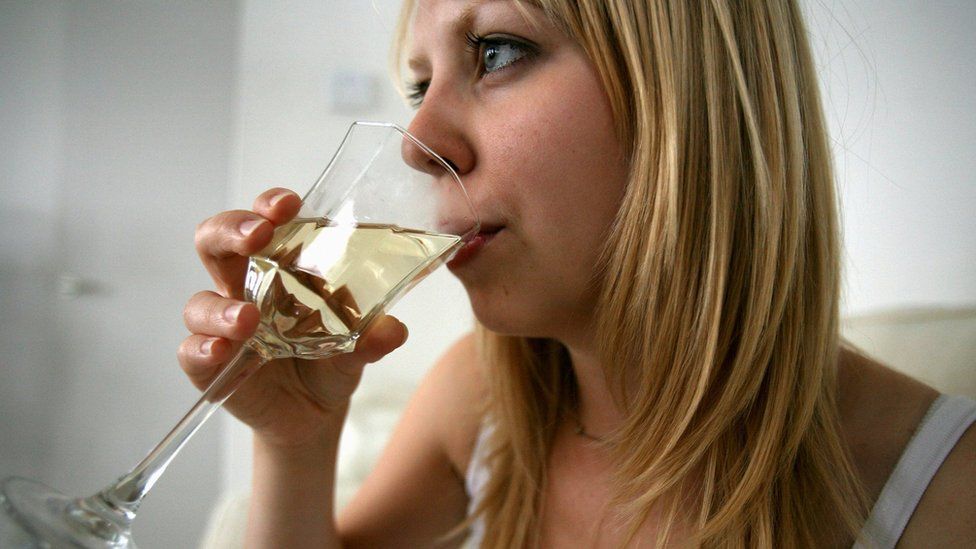 Woman drinking a glass of wine