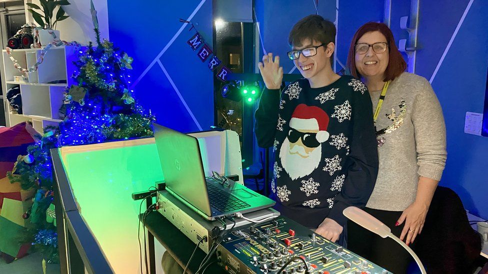 Young patient, George, and carer at the hospice Christmas party