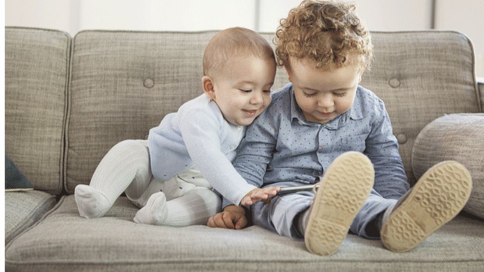 Toddler and baby looking at tablet