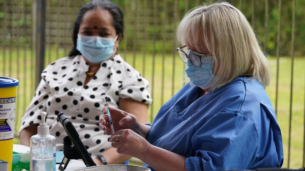 A woman preparing to give a vaccine