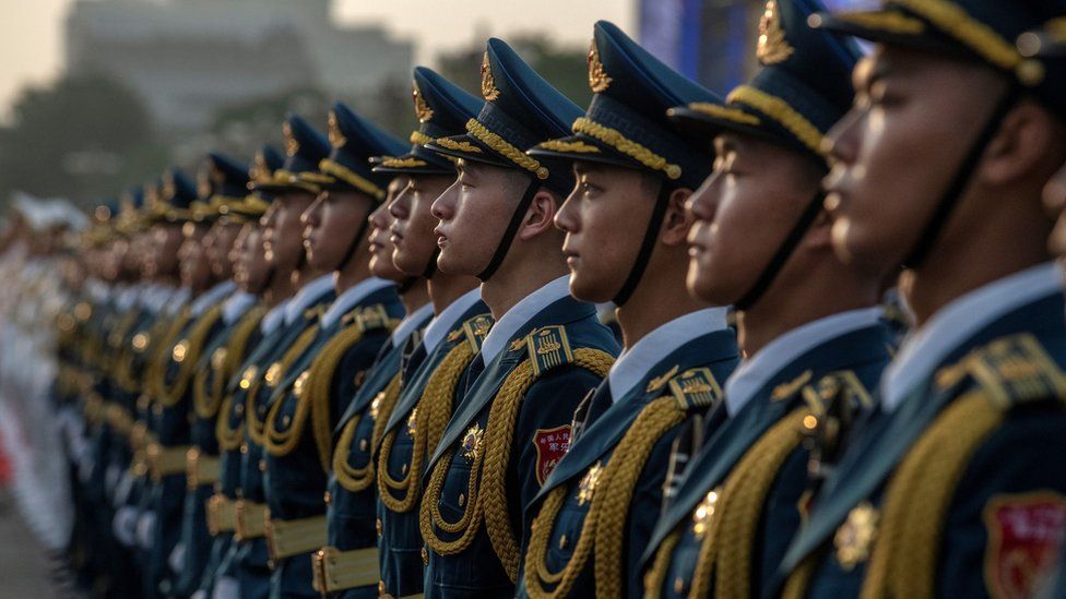 Soldiers in the People's Liberation Army stand to attention