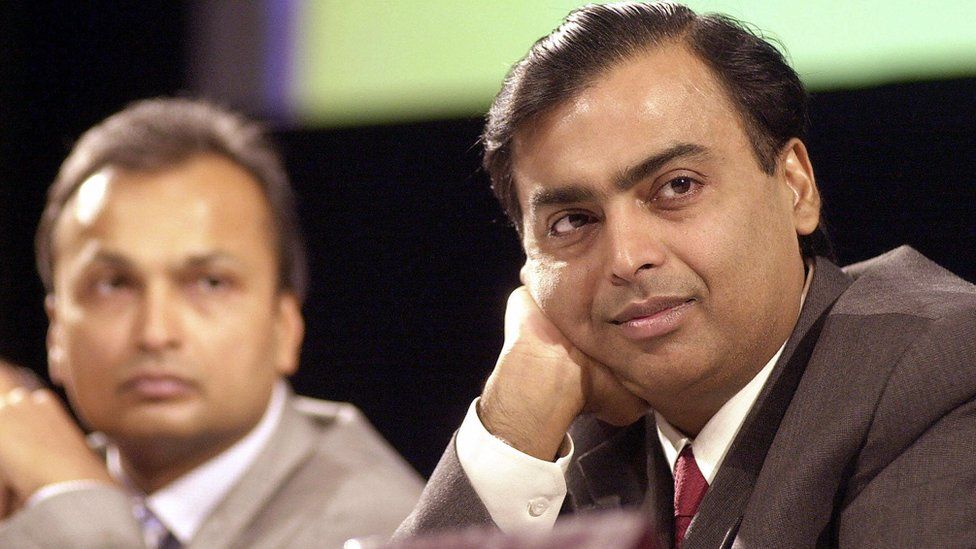 In this file picture dated 24 June 2004, India's largest private sector company Reliance Industries Chairman and Managing Director Mukesh Ambani (R) along with Vice Chairman Anil Ambani (L) listen to shareholders opinions at the company's Annual General Meeting (AGM)