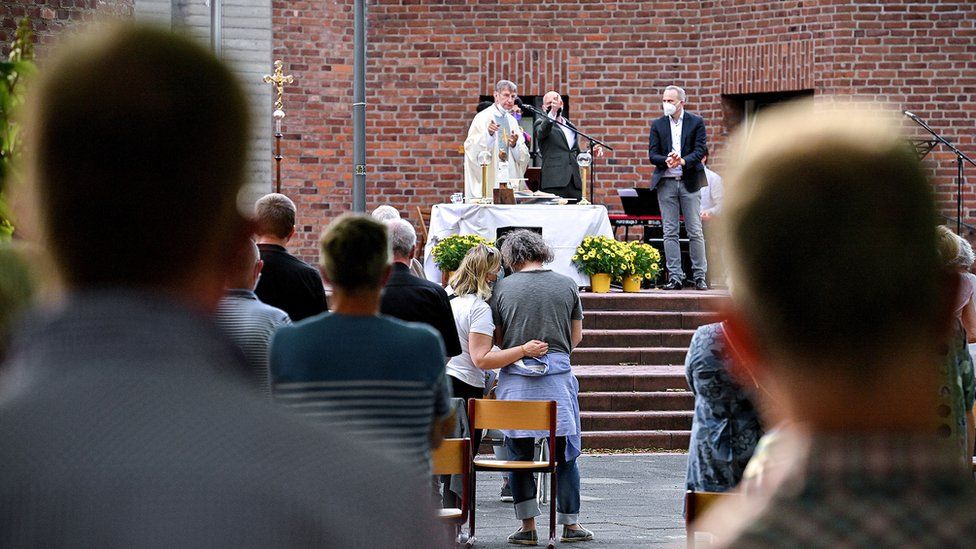 Couples attend a blessing outside a Catholic church in Cologne