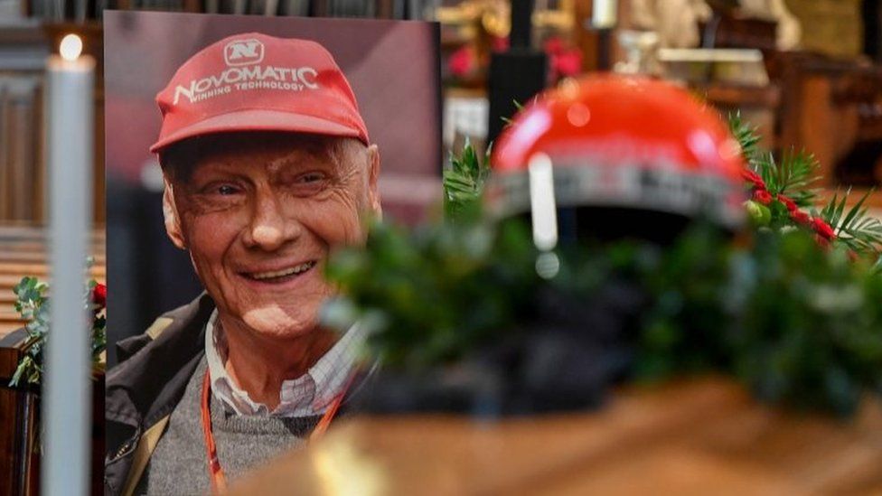 Niki Lauda's crash helmet is put on his coffin next to a picture of the driver at St Stephen's cathedral in Vienna, Austria. Photo: 29 May 2019