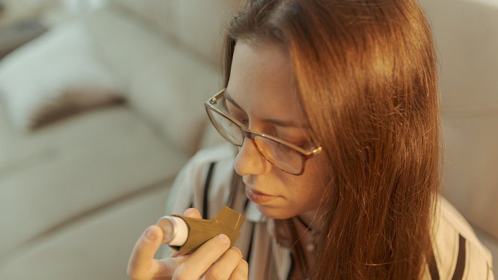 young woman with brown inhaler
