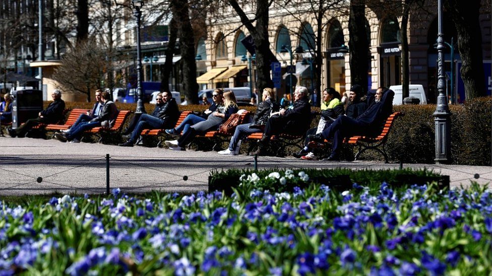 People enjoy a sunny day on the Esplanade in Helsinki, Finland, in May 2017