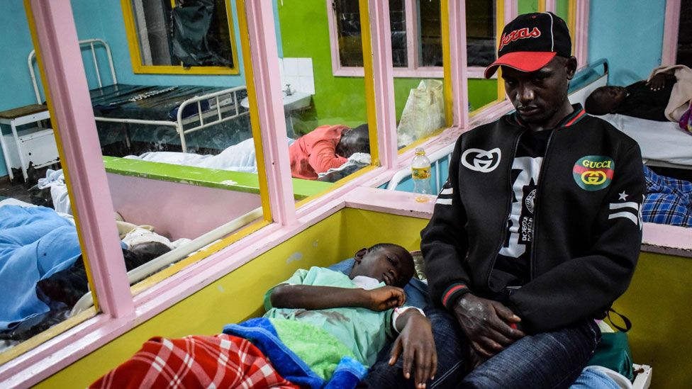 A parent sits next to her daughter as she gets treatment at Kakamega Hospital in Western Kenya on January 4, 2020