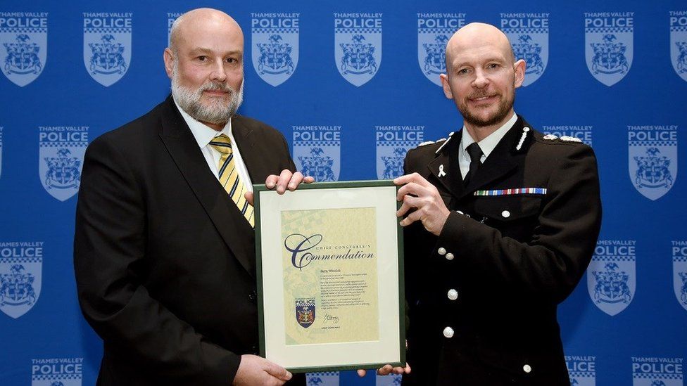 Financial investigator Barry Winslade with his award from Chief Constable Jason Hogg