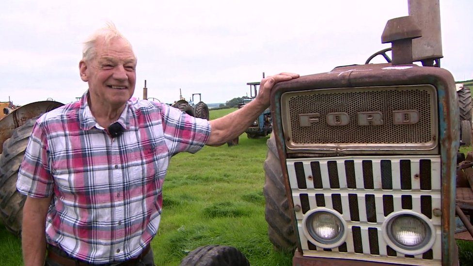 Phil Warren stood next to Ford tractor