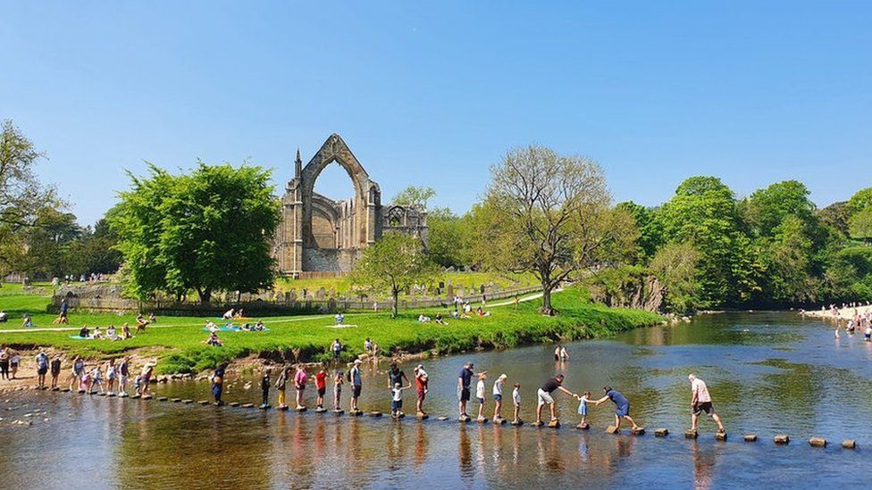People enjoy the sunshine at Bolton Abbey in Yorkshire on Bank Holiday Monday