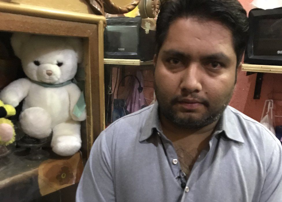 Asif Baba, Ayesha's father, with Ayesha's white teddy bear in the background