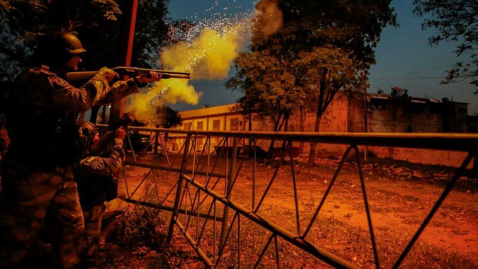 Police shoot at the Tacumbu penitentiary after inmates took hostage a dozen officials and caused a fire, in Asuncion, Paraguay October 10, 2023.