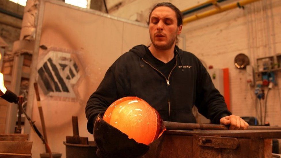 A man working in a glass-blowing factory