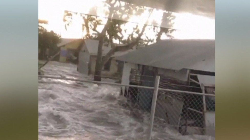 An unverified video shows water gushing past a church