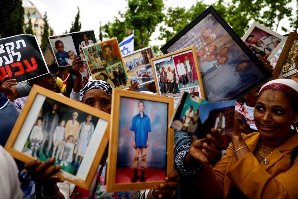 Israelis of Ethiopian descent hold up pictures of their relatives during a protest calling on the Israeli government to stop a freeze on Jewish Ethiopian immigration to Israel, outside the weekly cabinet meeting in Jerusalem, Israel - Sunday 28 May 2023