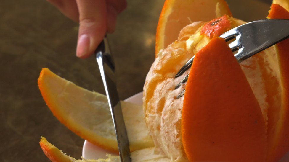 orange with knife and fork