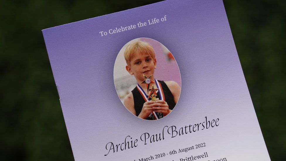 Archie Battersbee order of service for funeral, paper is gradient purple colour with an image of Archie holding a trophy at the top.
