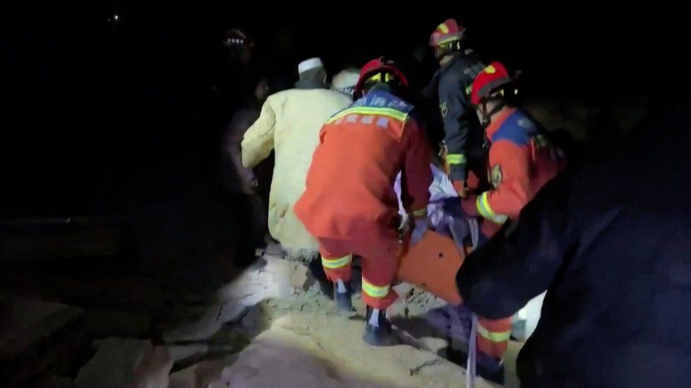 Rescuers seen amid rubble following an earthquake in north-west China.