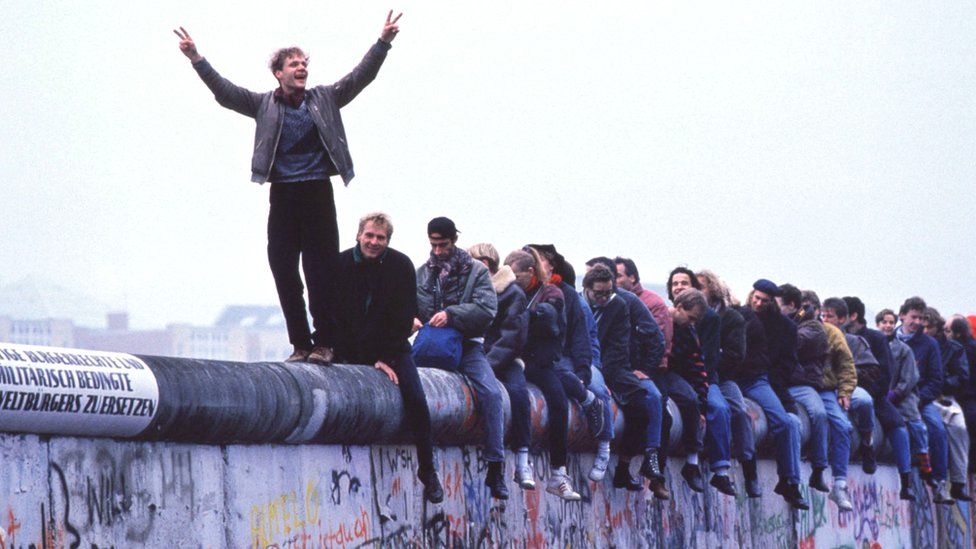 West Germans celebrate the collapse of communism atop the Berlin Wall, 12 November 1989