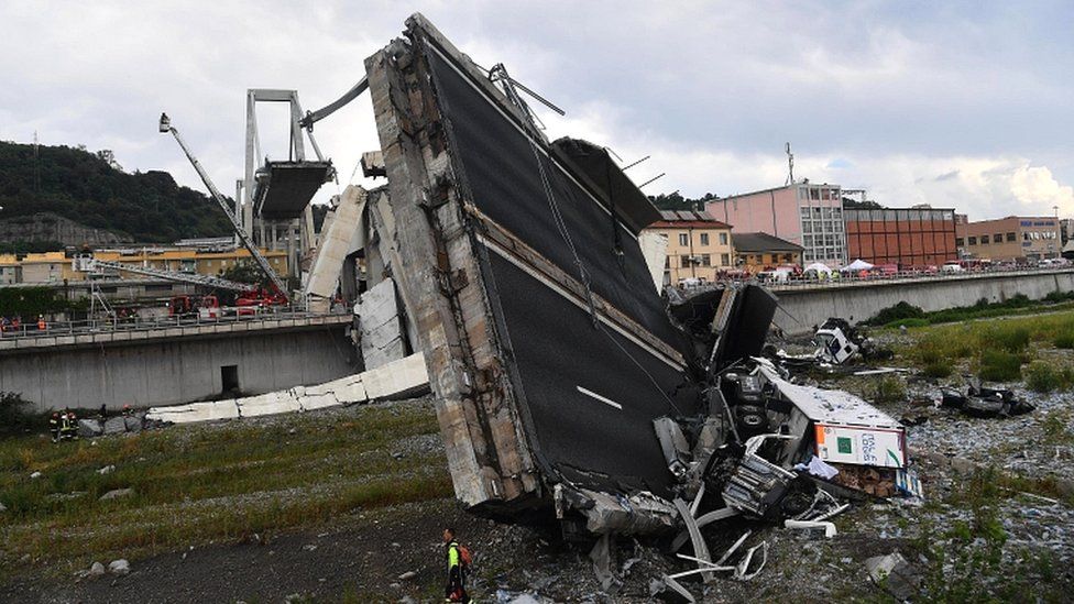 Rescuers at work at the site of the motorway bridge collapse in Genoa, Italy, on 14 August 2018