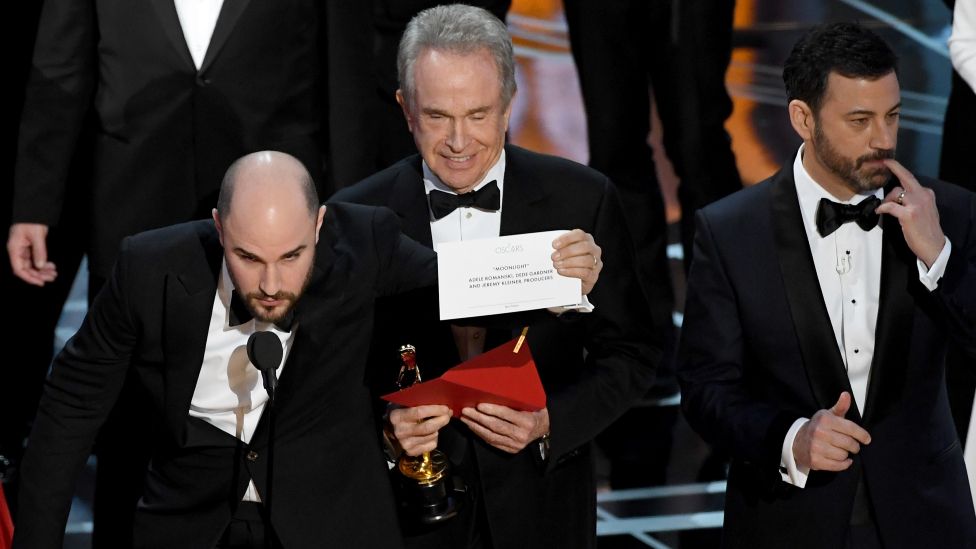 La La Land producer Jordan Horowitz (L) holds up the winner card reading actual best picture winner Moonlight after a presentation error with actor Warren Beatty and host Jimmy Kimmel onstage during the 89th Annual Academy Awards at Hollywood & Highland Center on February 26, 2017 in Hollywood, California
