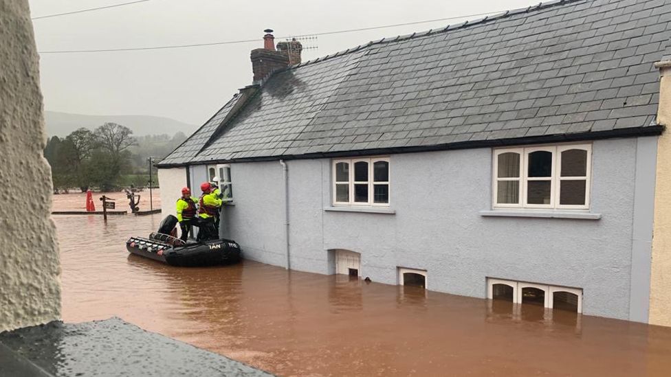A family on holiday were rescued from a cottage at Usk on the Wye