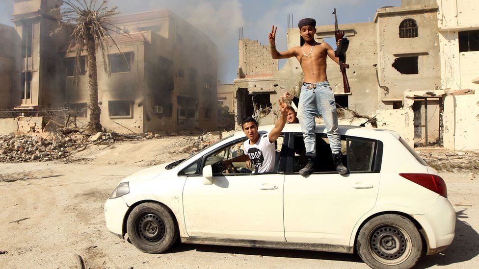 Fighters loyal to Libya's Tobruk-based government celebrate as they come close to seizing the centre of Benghazi - 23 February 2016