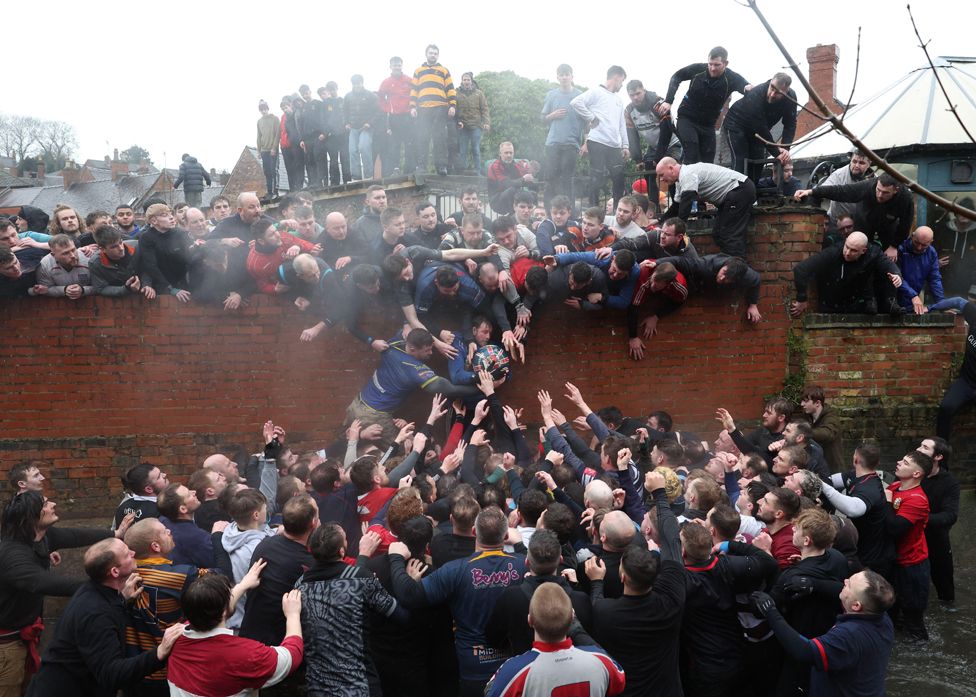 Contestants battle for the ball at The Royal Shrovetide Football match