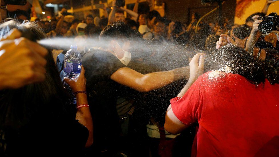 Protesters are pepper sprayed by police during a protest in Hong Kong