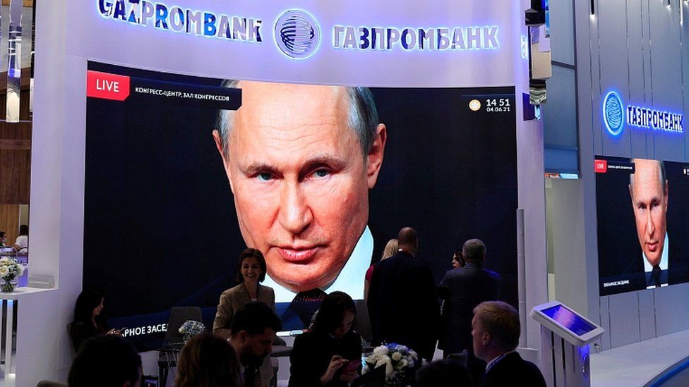 President Vladimir Putin is seen on a screen in St Petersburg, Russia, June 4, 2021