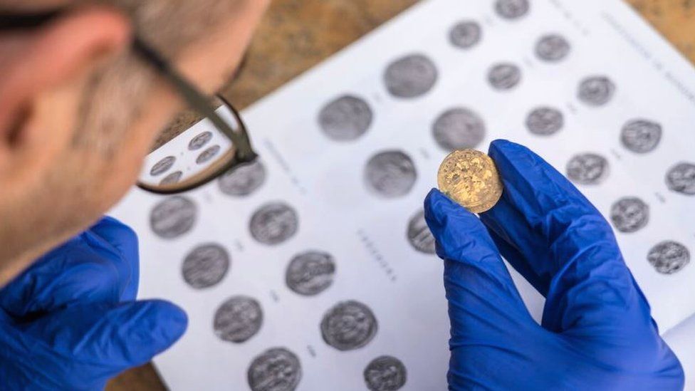 The coins are identified at the site