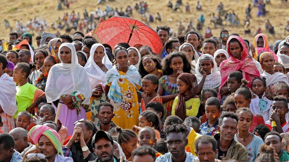 Ethiopian refugees gather to celebrate the 46th anniversary of the Tigray People's Liberation Front at Um Raquba refugee camp in Gedaref, eastern Sudan, on February 19, 2021.