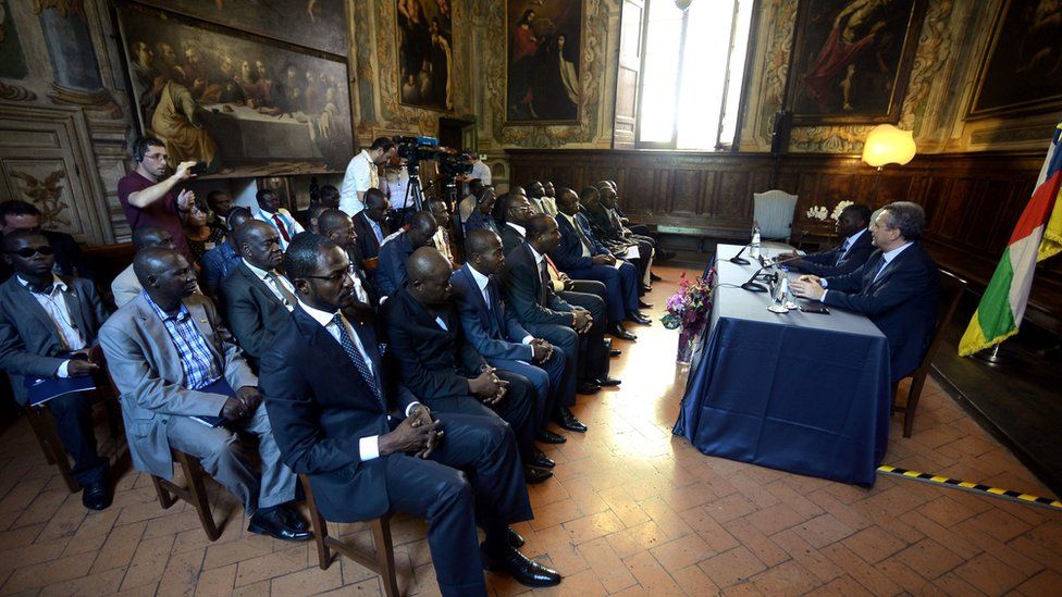 Sant'Egidio President Marco Impagliazzo (R) addresses a delegation from Central African Republic on June 19, 2017 inside the Sant'Egidio community church in Rome