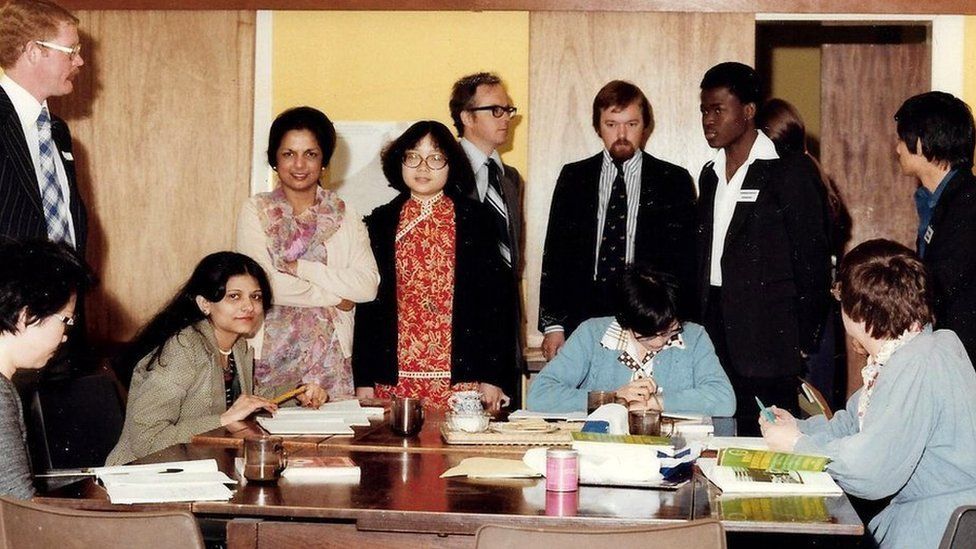 Saroj Lal and other community workers standing round a table at the YWCA Roundabout Centre in Leith in the 1970s