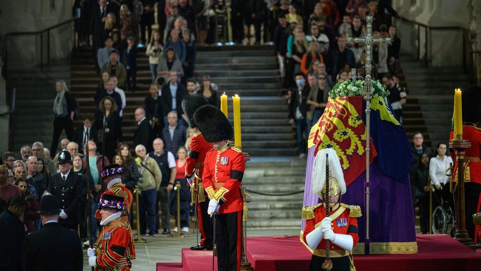 Members of the public walk past Queen Elizabeth II's coffin in Westminster Hall