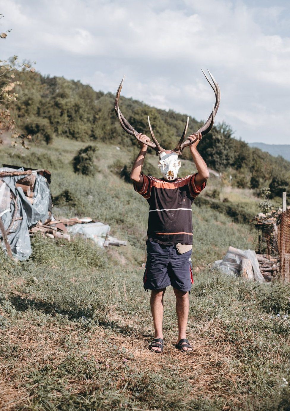 Person holding an animal skull outdoors