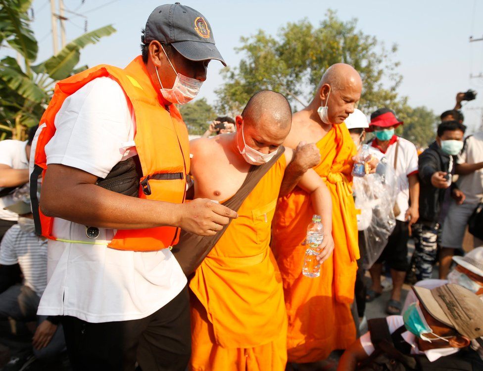 An injured Thai Buddhist monk of Dhammakaya Temple is helped after clashes with police officers outside the temple in Pathum Thani province, on the outskirts of Bangkok, Thailand, 20 February 2017