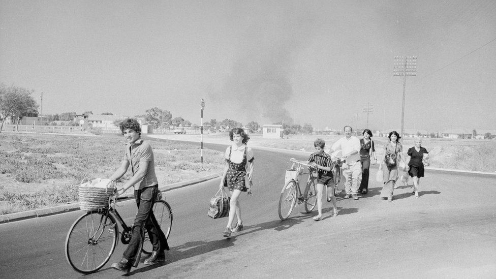 August 1974: A trail of people making their way down a road in Cyprus during a period of fighting between Greek and Turkish Cypriots.