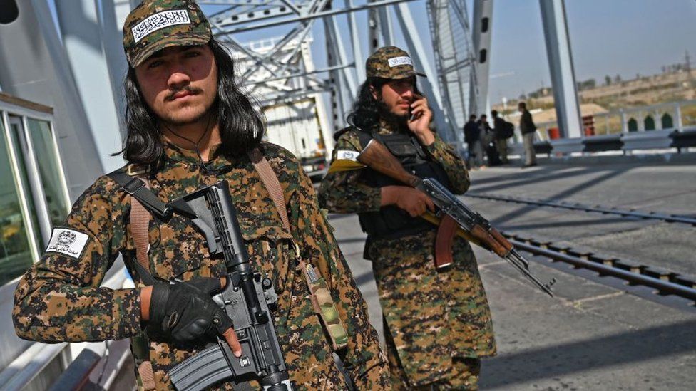 Taliban border guards on a bridge near the Uzbekistan border