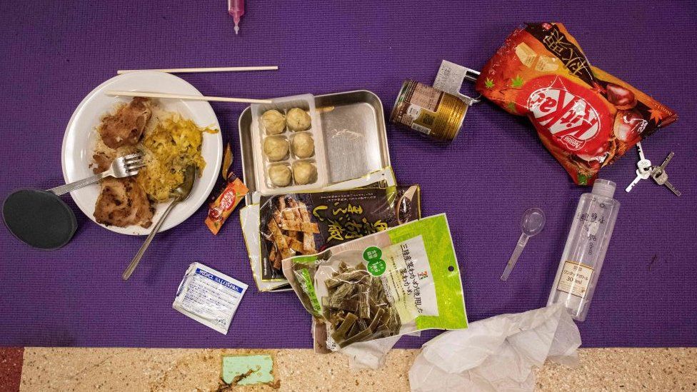 Food left over by a protester is seen on a mat on the floor inside the Hong Kong Polytechnic University