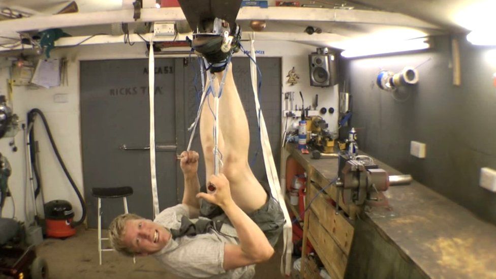 Colin Furze walking on the ceiling with magnetic shoes