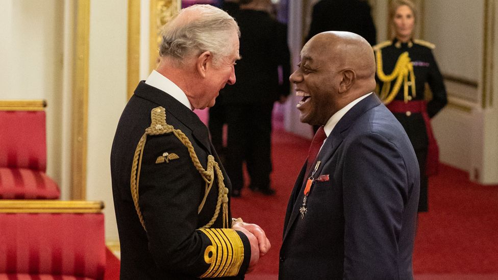 Ainsley Harriott receives 'very special' MBE from Prince Charles - BBC News