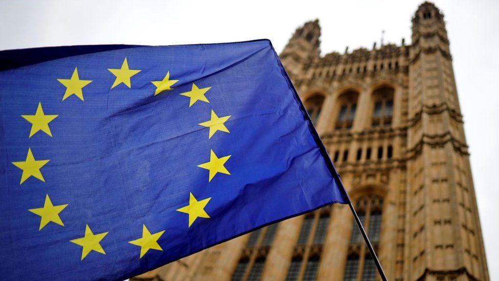 A European Union flag flies outside the Houses of Parliament in London, 23 October 2019