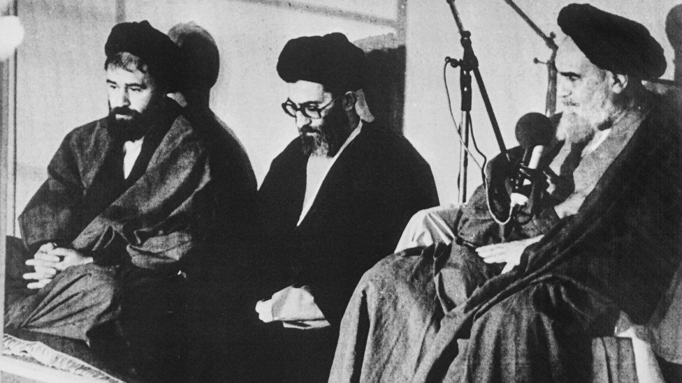 Ali Khamenei (C) is invested as the third president of the Islamic Republic of Iran by Ruhollah Khomeini (R) (9 October 1981)