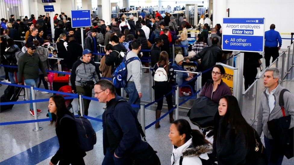 Travelers arrive for TSA inspection as they make their way through Newark Liberty International Airport in Newark, New Jersey