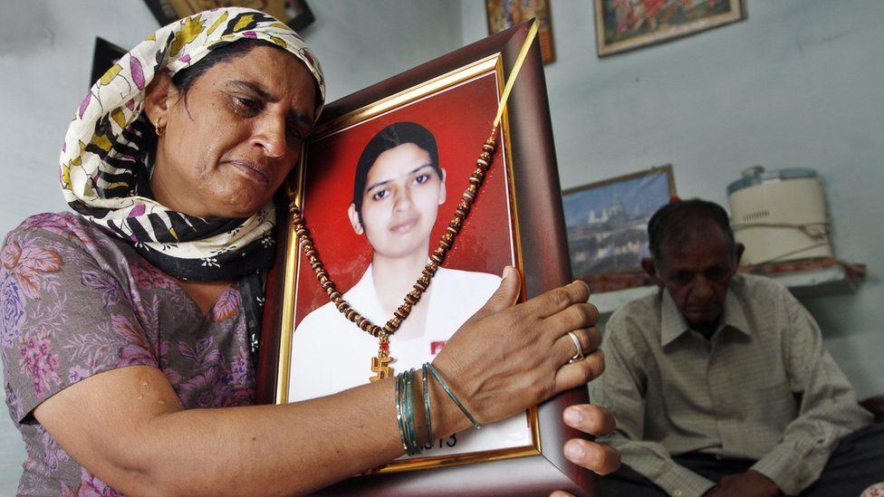 Preeti Rathi's parents with a photograph of their daughter