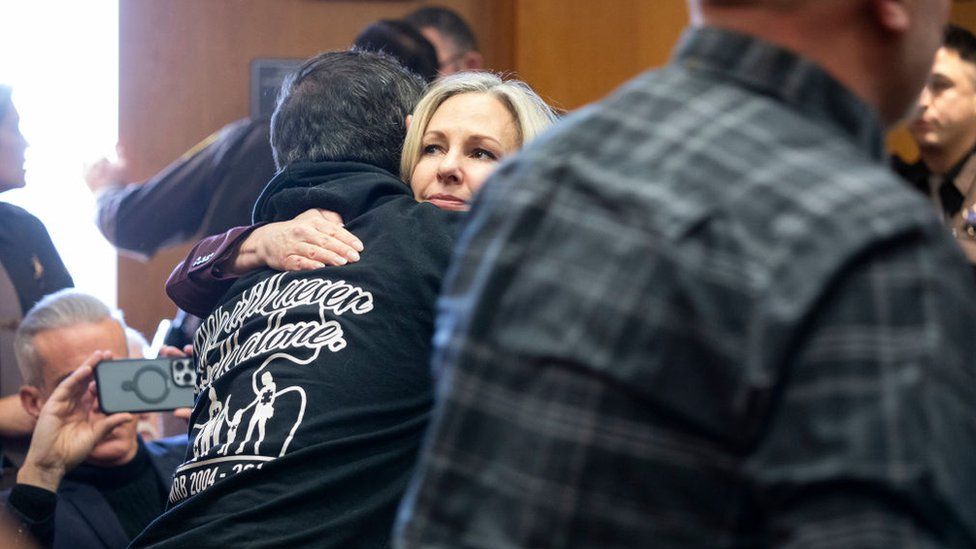Oakland County Prosecutor Karen McDonald hugs a family member of a student killed by Ethan Crumbley, after a jury found his mother guilty