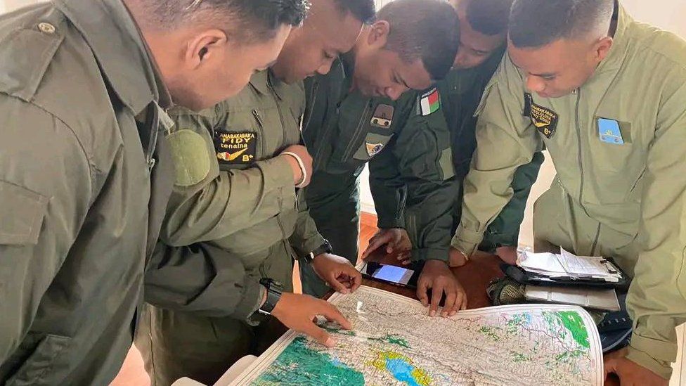Officers tasked with hunting the cattle rustlers looking at a map in Madagascar - 30 July 2022
